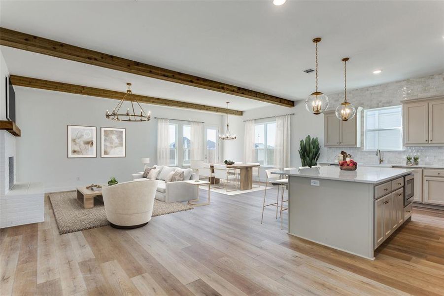 Kitchen featuring a chandelier, a kitchen island, a kitchen breakfast bar, decorative backsplash, and recessed lighting