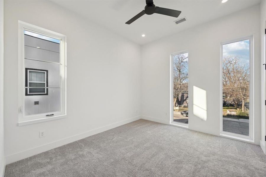 Spare room featuring light colored carpet and ceiling fan