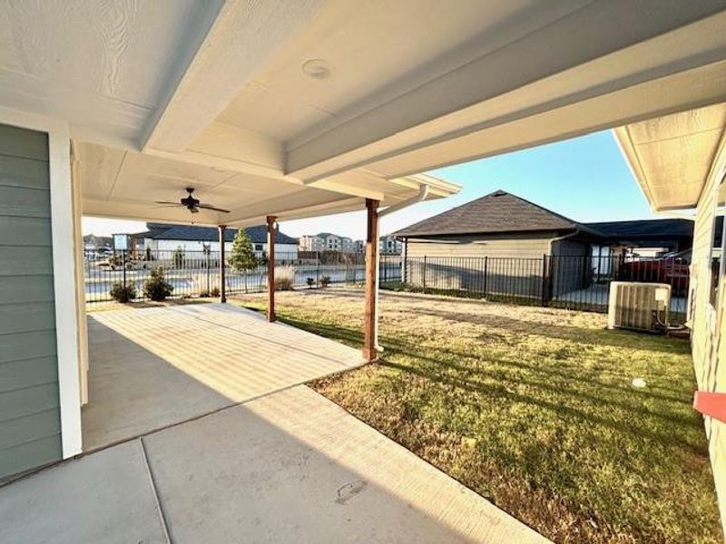 View of yard featuring central air condition unit, ceiling fan, and a patio