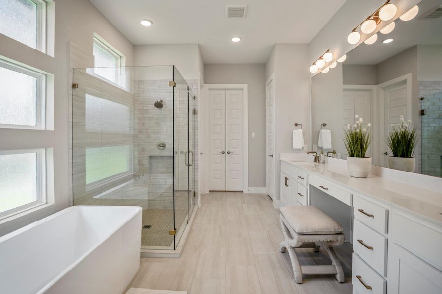 Enjoy a daily dose of luxury in this spa-inspired ensuite, where a deep soaking tub, oversized walk-in shower, dual-sink vanity and polished designer finishes create the perfect place to unwind and pamper yourself.