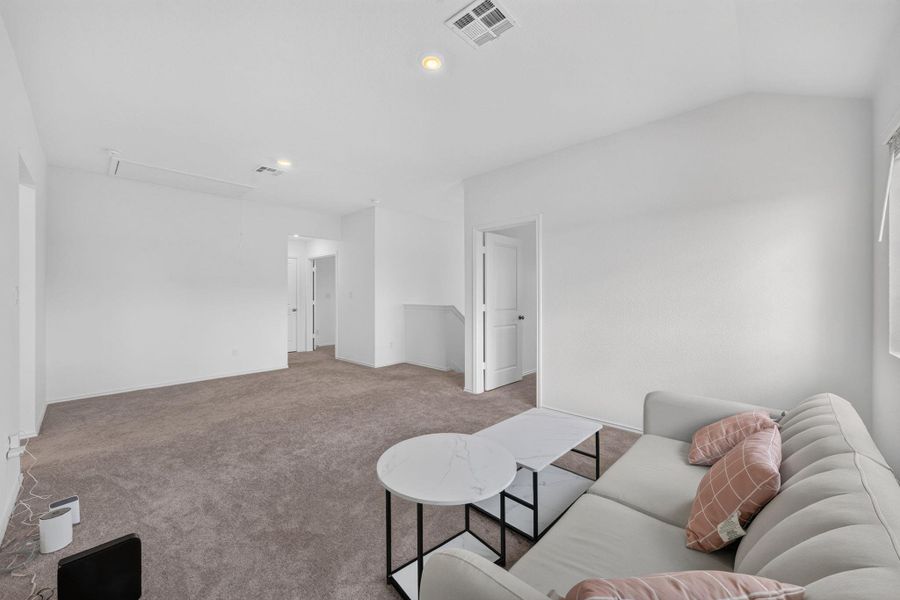 A spacious upper-level area features plush carpeting and clear sightlines to the interior doorways. A spacious upper-level area features plush carpeting and clear sightlines to the interior doorways.