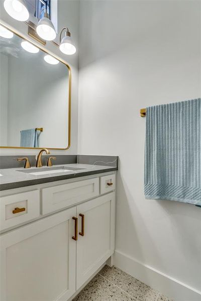 Model Home Bathroom featuring vanity and dark aggregate flooring