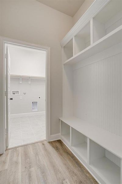 Mudroom with light hardwood / wood-style floors