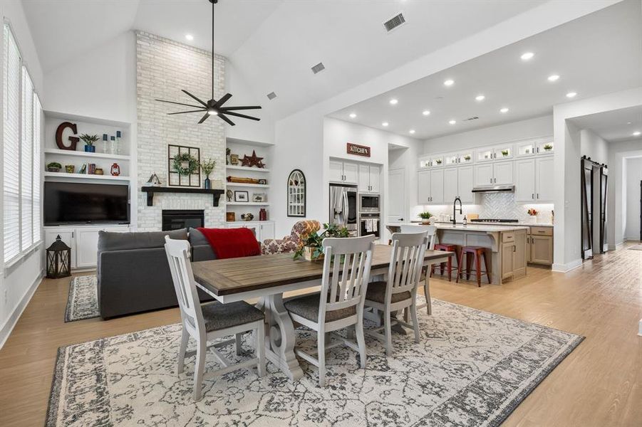 Expansive living area with high vaulted ceilings and light wood-finish flooring Expansive living area with high vaulted ceilings and light wood-finish flooring