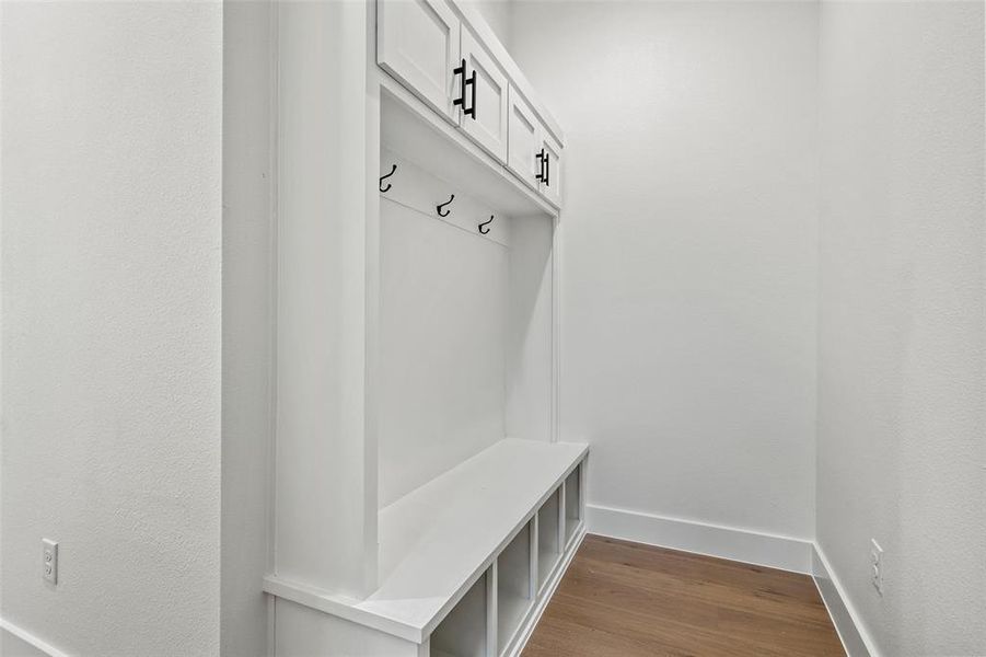 Mudroom featuring dark wood-style flooring and baseboards Mudroom featuring dark wood-style flooring and baseboards