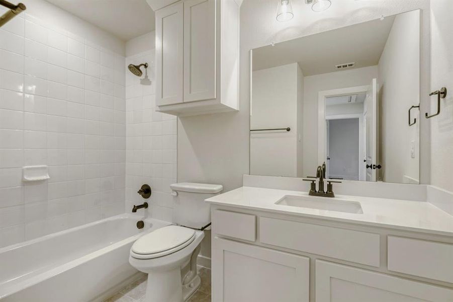 Bathroom featuring shower / tub combination and vanity