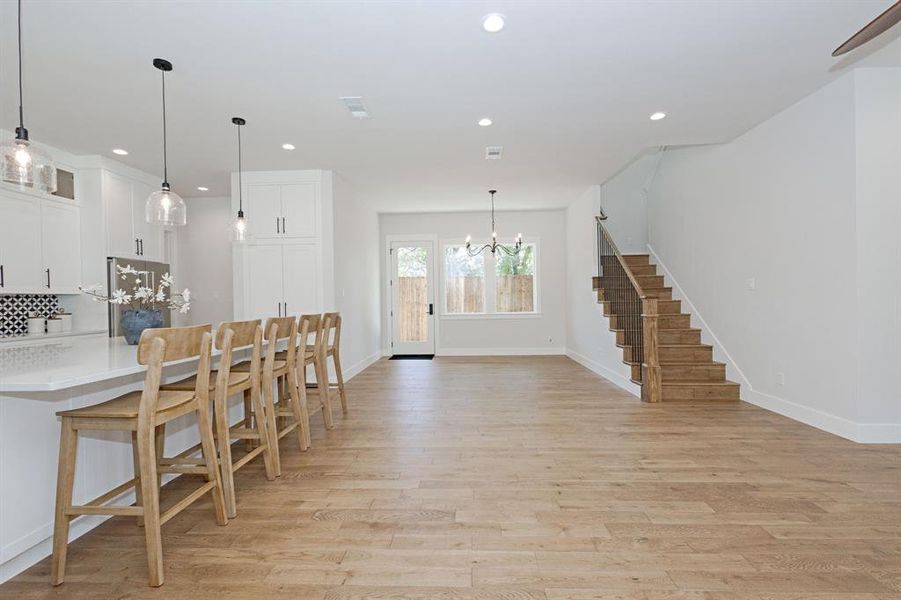 Open, airy Dining Area anchored by a Statement Chandelier. Open, airy Dining Area anchored by a Statement Chandelier.