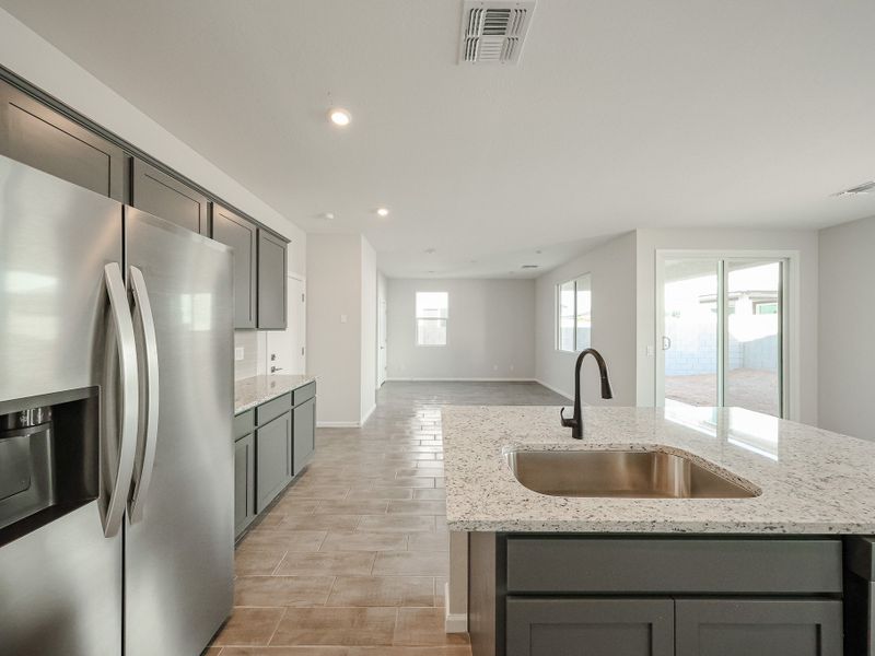 A kitchen with a marble counter top. A kitchen with a marble counter top.