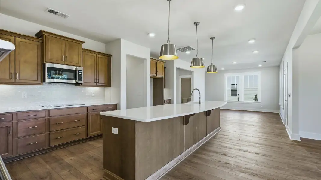 Accomplished kitchen design featuring pendant lighting above a statement island for both prep and gathering Accomplished kitchen design featuring pendant lighting above a statement island for both prep and gathering
