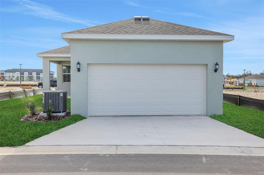 Front exterior of a new home in Crossroads at Kelly Park, Apopka, FL, highlighting curb appeal (Image 21).