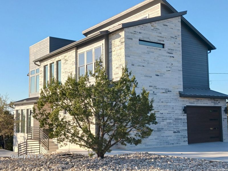 Front exterior of a new home in , Canyon Lake, TX, highlighting curb appeal (Image 18).