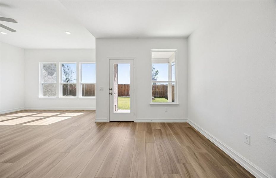 Dining nook off kitchen with large windows Dining nook off kitchen with large windows