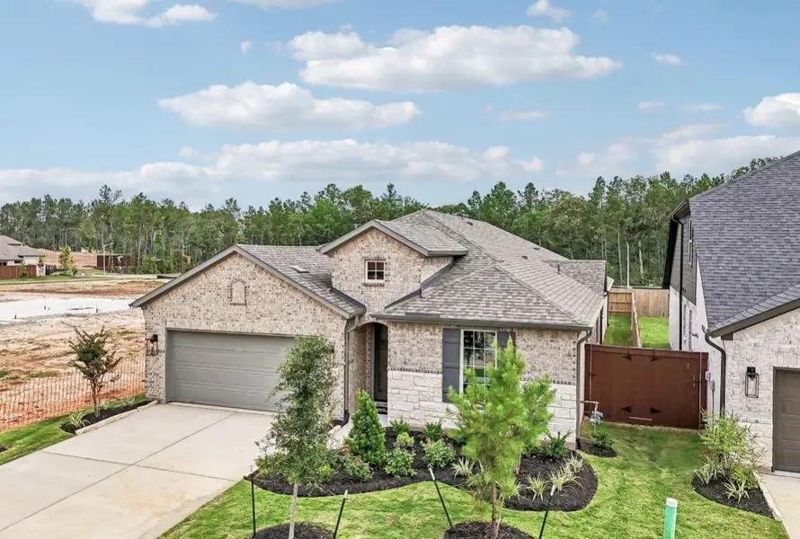 Front exterior of a new home in WILDTREE 50', Montgomery, TX, highlighting curb appeal (Image 2). Front exterior of a new home in WILDTREE 50', Montgomery, TX, highlighting curb appeal (Image 2).