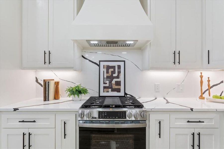 Kitchen with custom range hood, stainless steel range with gas stovetop, etc. Kitchen with custom range hood, stainless steel range with gas stovetop, etc.