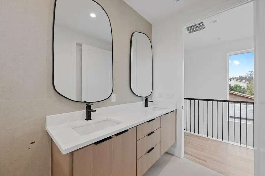 Full bathroom featuring double vanity, light wood-style flooring, and recessed lighting