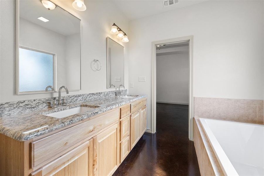 Bathroom with double vanity and garden tub