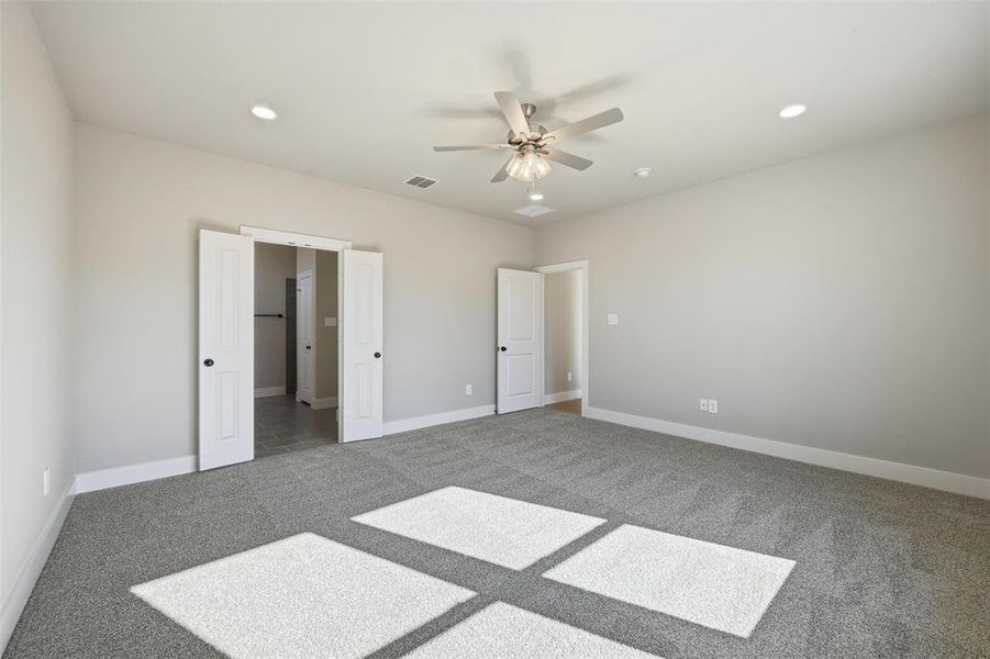 Unfurnished bedroom with recessed lighting, carpet flooring, and ceiling fan Unfurnished bedroom with recessed lighting, carpet flooring, and ceiling fan