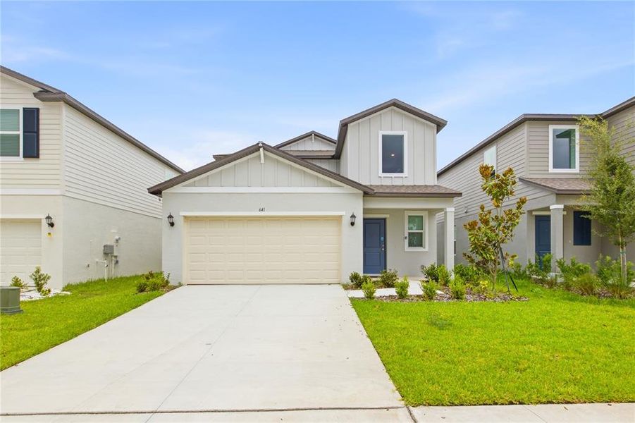 Front exterior of a new home in Cypress Point at Lake Parker, Lakeland, FL, highlighting curb appeal (Image 2). Front exterior of a new home in Cypress Point at Lake Parker, Lakeland, FL, highlighting curb appeal (Image 2).