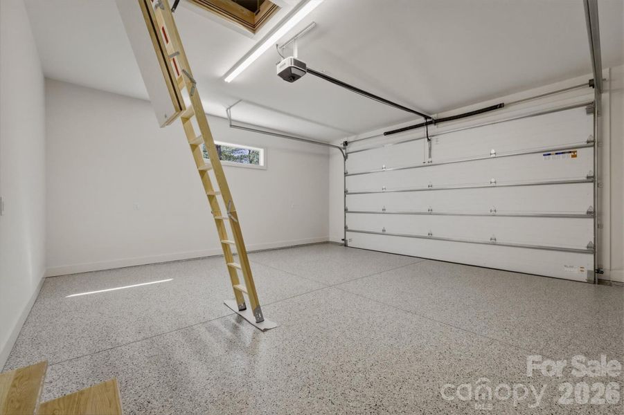 Before leaving the main level, let's check out the 2 car garage. The concrete floors were coated with Torginol Epoxy Flake Garage Floor Coating which truly elevate the garage area into a showroom floor. The transom window lets light in without giving up the privacy or wall space. There are pulldown stairs into the attic here as well. TThe top of the line Lift Master garage door opener allows control from your phone anywhere in the world. Check to ensure the door is closed. Program the opener to ensure it is closed every night and many more features. Before leaving the main level, let's check out the 2 car garage. The concrete floors were coated with Torginol Epoxy Flake Garage Floor Coating which truly elevate the garage area into a showroom floor. The transom window lets light in without giving up the privacy or wall space. There are pulldown stairs into the attic here as well. TThe top of the line Lift Master garage door opener allows control from your phone anywhere in the world. Check to ensure the door is closed. Program the opener to ensure it is closed every night and many more features.