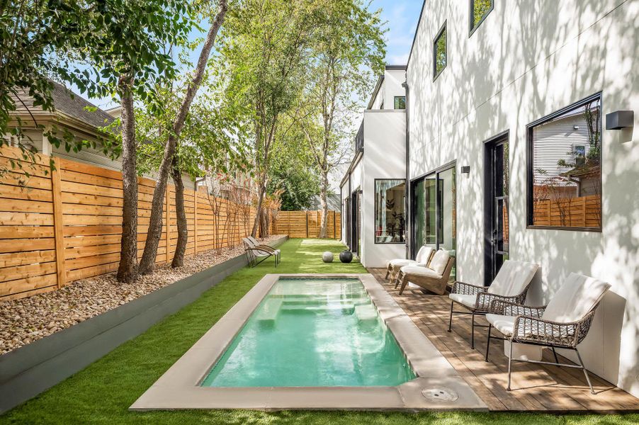 View of swimming pool with a full fenced backyard and a patio sitting area outside of primary suite