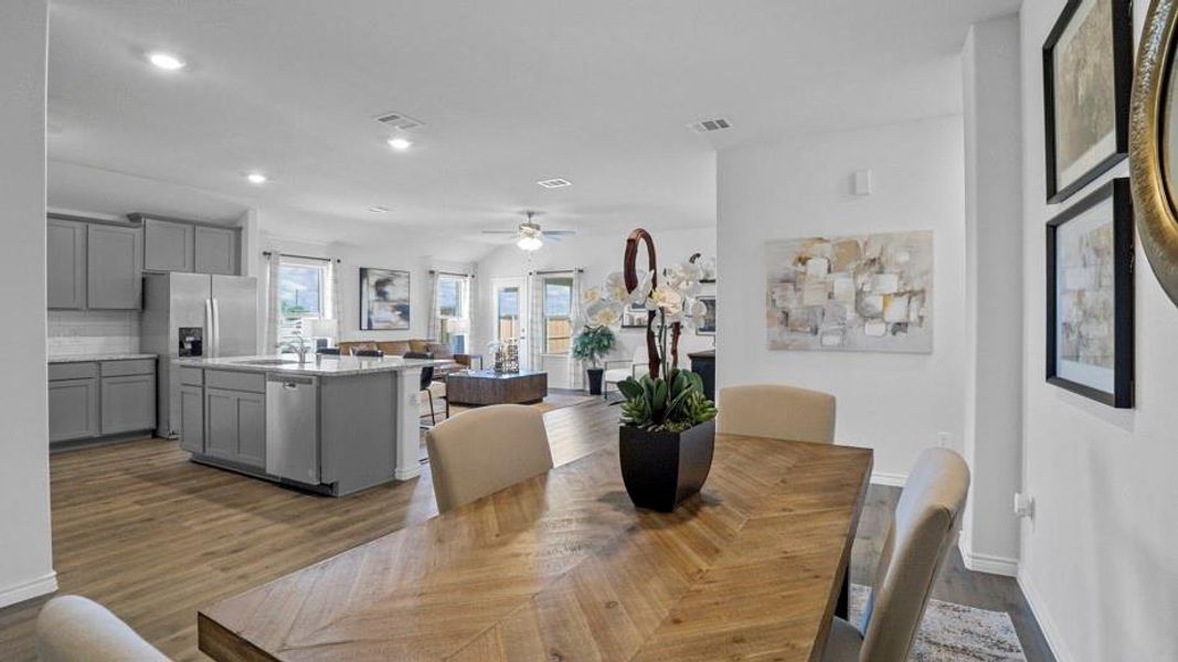 Dining area featuring dark wood finished floors, a ceiling fan, and recessed lighting