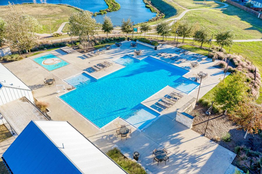 Community pool featuring a water view and a patio