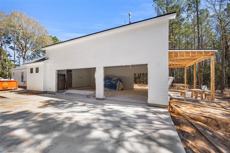 Oversized 3-car garage with extended driveway with room for more including a workspace