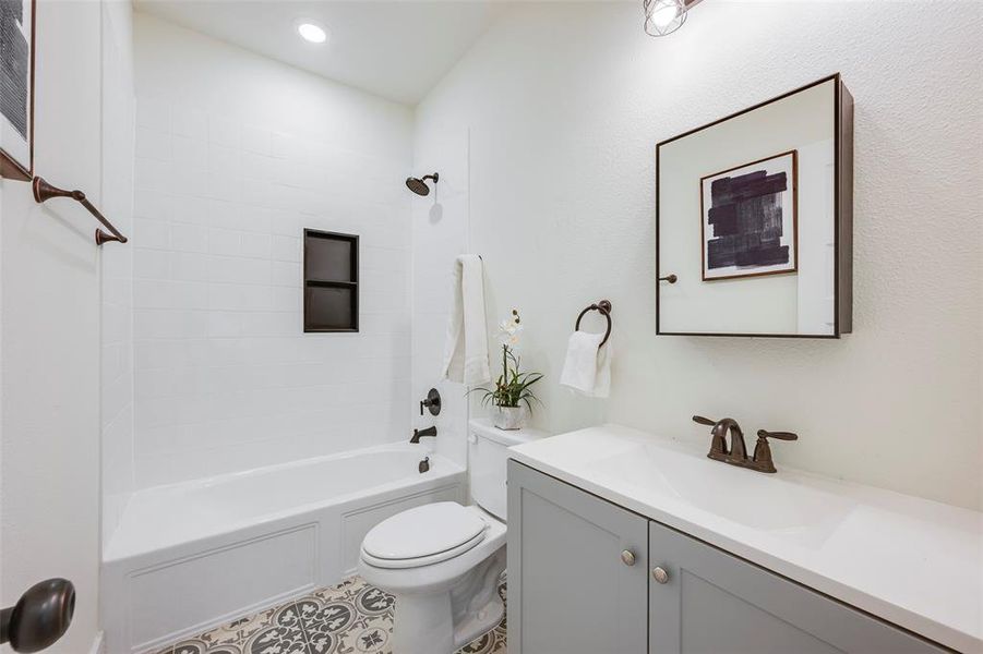 Full bath with shower / bath combination, vanity, and tile patterned flooring