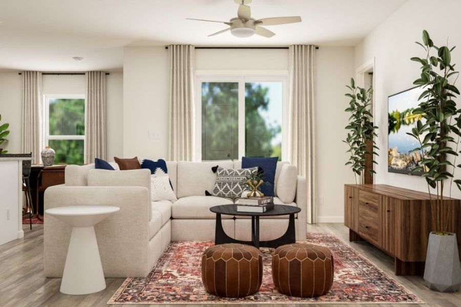 A living room with a white couch and a fan. A living room with a white couch and a fan.
