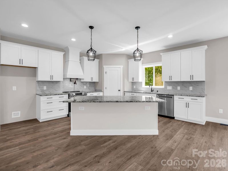 Chef's kitchen with oversized granite island, built in microwave drawer, stainless appliances, soft close cabinets, pot filler and custom walk-in pantry Chef's kitchen with oversized granite island, built in microwave drawer, stainless appliances, soft close cabinets, pot filler and custom walk-in pantry