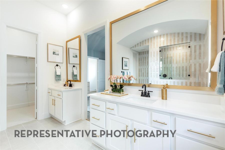 Bathroom featuring tiled shower, a sink, two vanities, tile patterned flooring, and a spacious closet Bathroom featuring tiled shower, a sink, two vanities, tile patterned flooring, and a spacious closet
