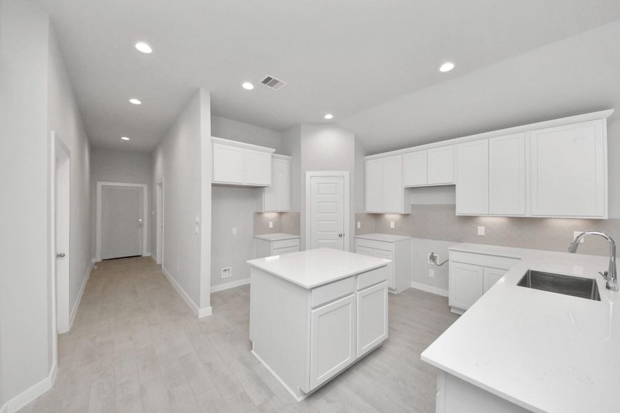 The open concept effortlessly connects the kitchen to the expansive family room, forming a perfect hub for gatherings. This seamless flow creates an inviting space where cooking and socializing come together harmoniously. Sample photo of completed home with similar floor plan. Actual colors and selections may vary.