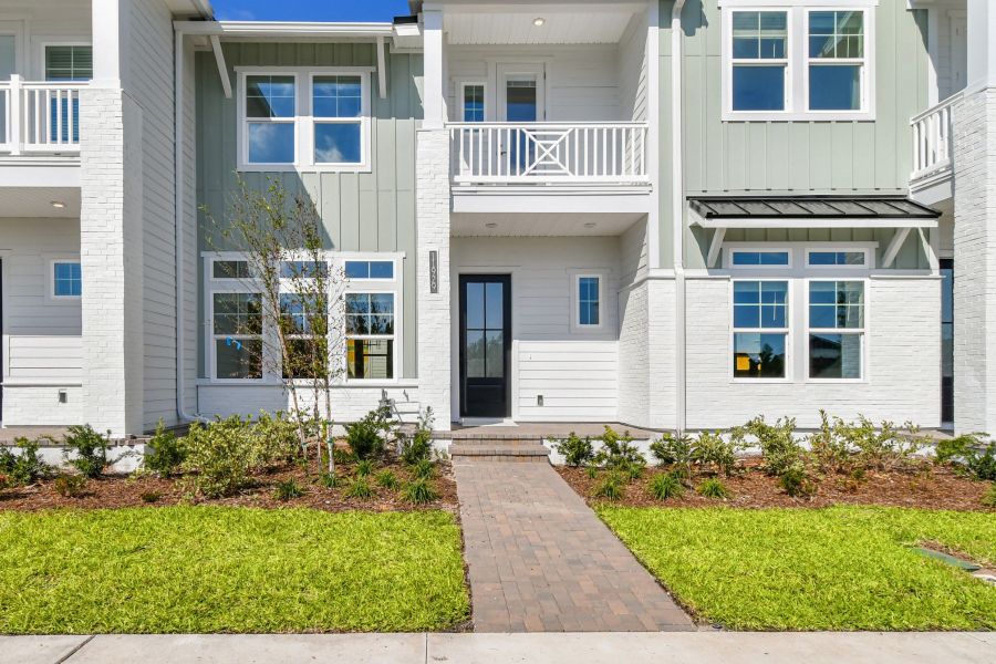 Exterior details and patio area of a home in Seven Pines 24' Rear Entry Townhomes, Jacksonville (Image 20).