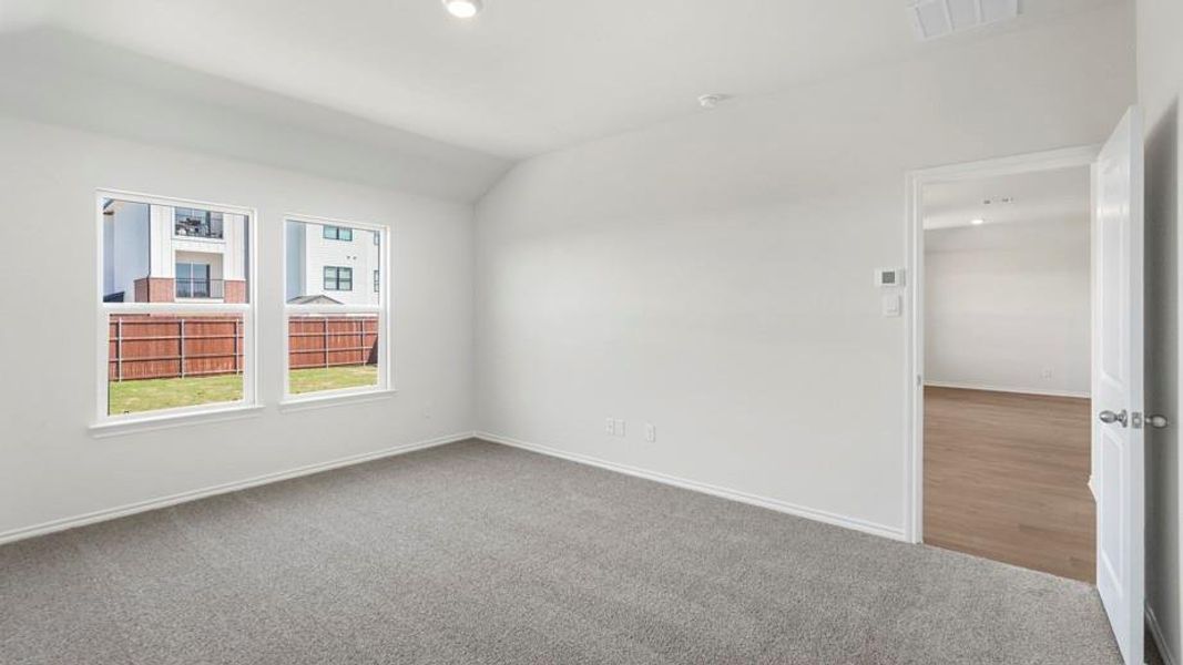 Carpeted interior space with white walls and baseboards