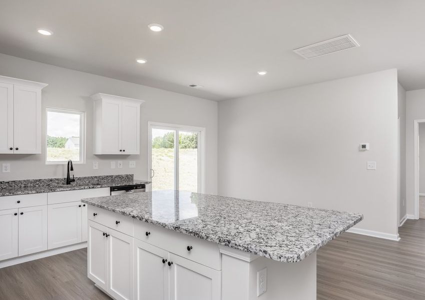 The kitchen has designer wood cabinetry