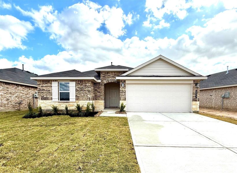 Front exterior of a new home in Porters Mill, New Caney, TX, highlighting curb appeal (Image 1).