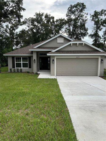Front exterior of a new home in Orange Blossom Hills, Summerfield, FL, highlighting curb appeal (Image 1). Front exterior of a new home in Orange Blossom Hills, Summerfield, FL, highlighting curb appeal (Image 1).