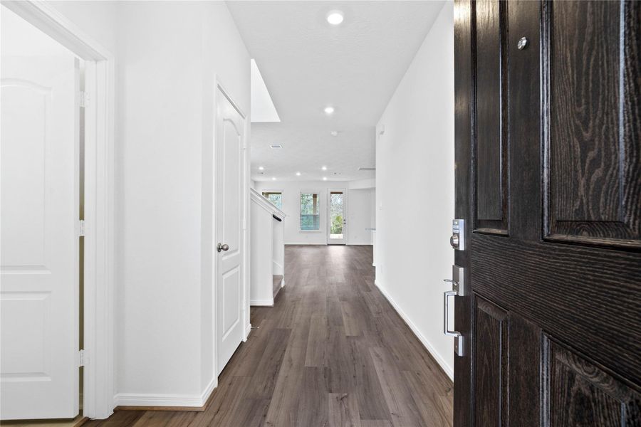 Upon entering this gorgeous home, a lovely corridor features custom paint, beautiful Layton Lake vinyl plank floors, high ceilings, recessed lighting and a coat closet! Upon entering this gorgeous home, a lovely corridor features custom paint, beautiful Layton Lake vinyl plank floors, high ceilings, recessed lighting and a coat closet!