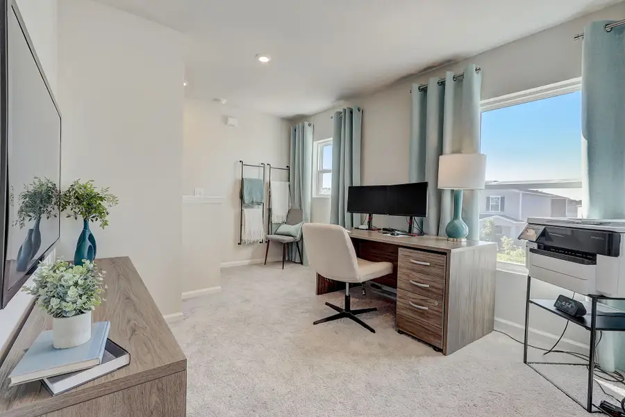 A room with a desk and a chair.