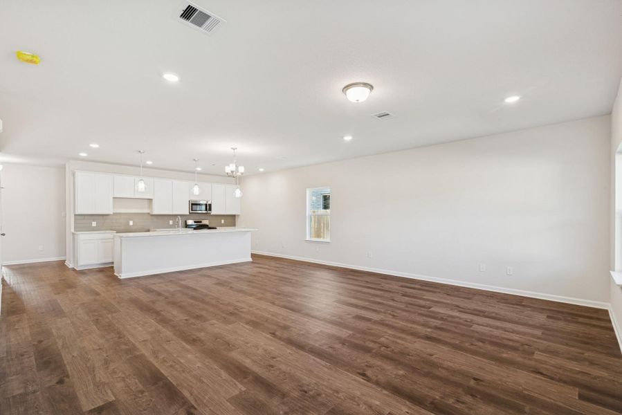 The Crawford- Family Room into Dining and Kitchen. Sample image for illustration; upgrades, options, and colors may vary. The Crawford- Family Room into Dining and Kitchen. Sample image for illustration; upgrades, options, and colors may vary.