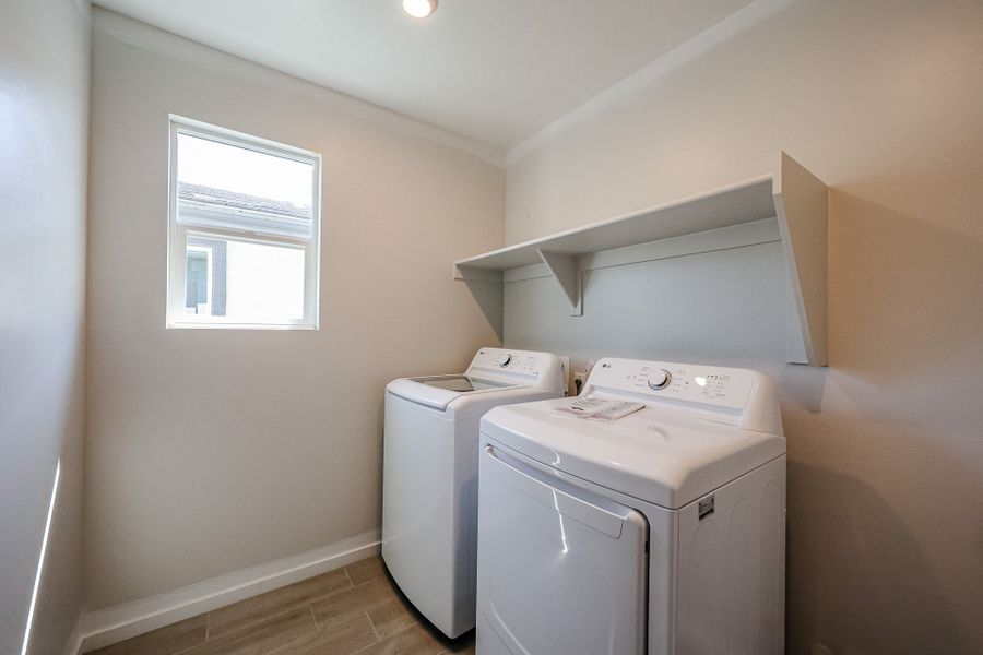 A washing machine in a room. A washing machine in a room.