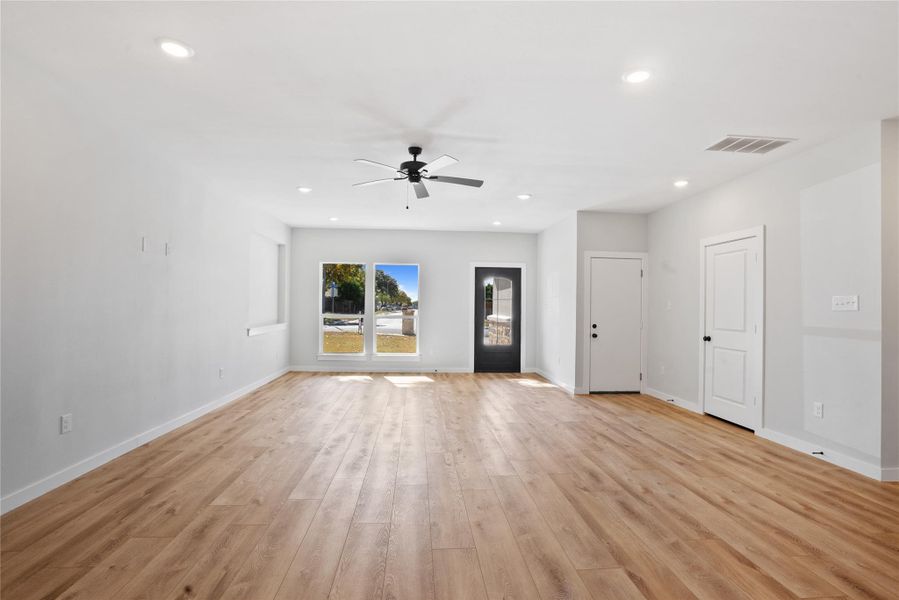 Unfurnished living room featuring light wood-style flooring, recessed lighting, and ceiling fan