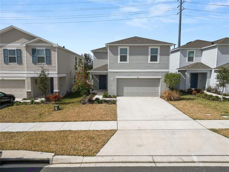 Front exterior of a new home in Marion Creek, Haines City, FL, highlighting curb appeal (Image 2). Front exterior of a new home in Marion Creek, Haines City, FL, highlighting curb appeal (Image 2).