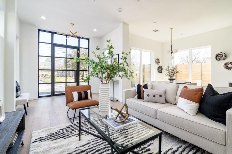 Living area featuring a wealth of natural light, wood finished floors, and recessed lighting