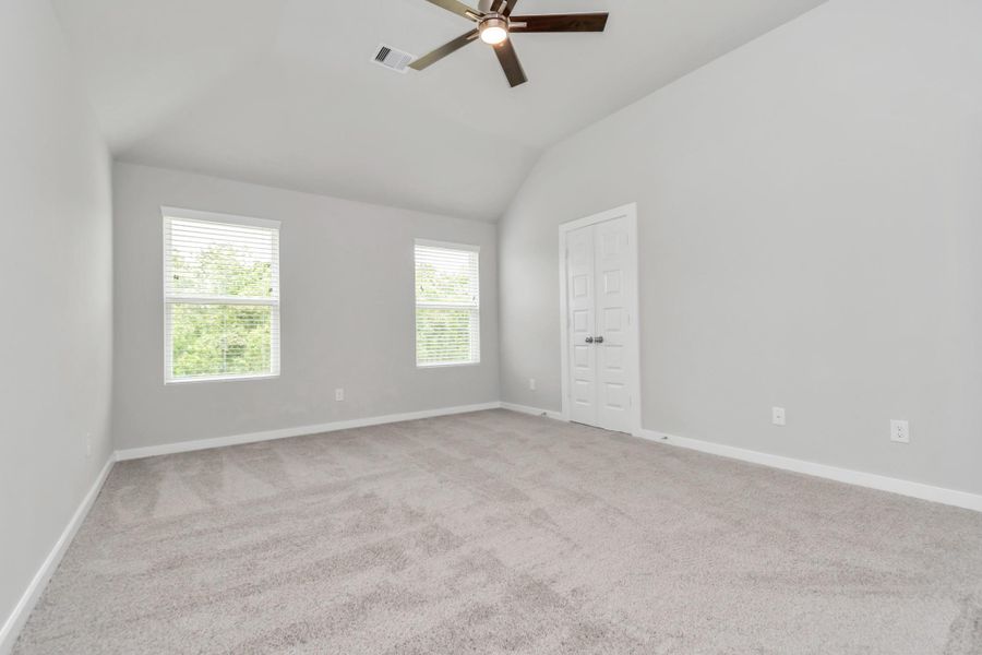 Escape to tranquility in this spacious primary room, adorned with plush carpeting and bathed in the soothing hues of warm paint colors, creating a cozy retreat for relaxation. Sample photo of completed home with similar floor plan. Actual colors and selections may vary. Escape to tranquility in this spacious primary room, adorned with plush carpeting and bathed in the soothing hues of warm paint colors, creating a cozy retreat for relaxation. Sample photo of completed home with similar floor plan. Actual colors and selections may vary.