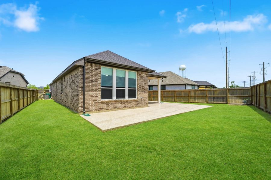 Spacious backyard with newly installed gate and stained fencing. Spacious backyard with newly installed gate and stained fencing.