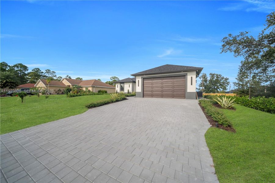 Front exterior of a new home in , Lehigh Acres, FL, highlighting curb appeal (Image 27).
