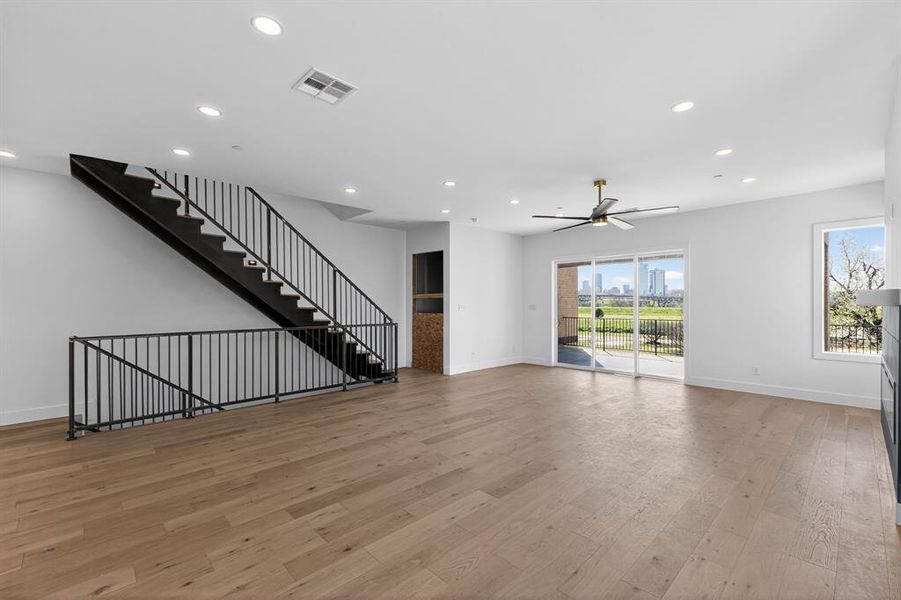 Unfurnished living room featuring ceiling fan, light wood-type flooring, and recessed lighting