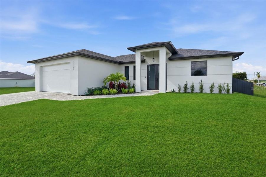 Front exterior of a new home in , Cape Coral, FL, highlighting curb appeal (Image 1).