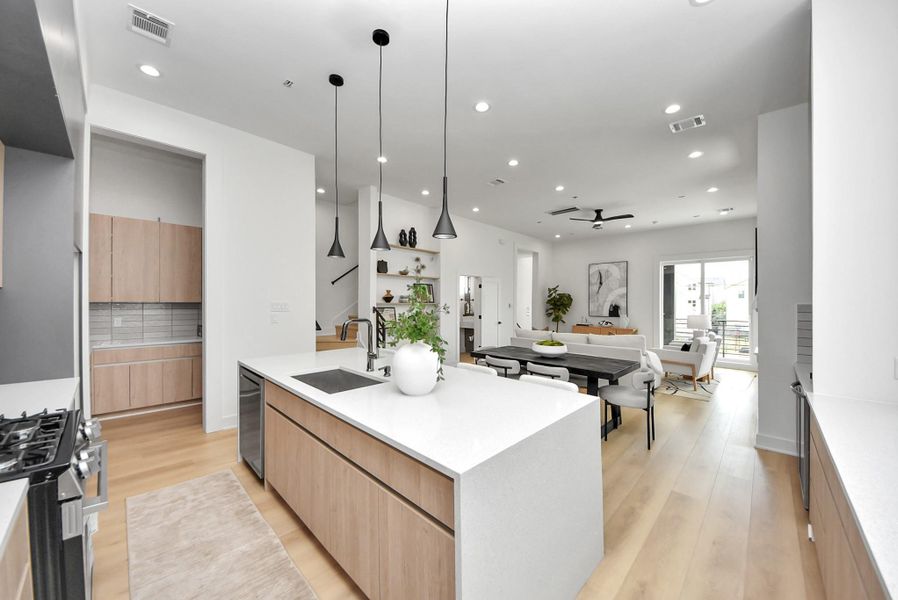 Open-concept kitchen flows seamlessly into the dining and living areas, ideal for entertaining.